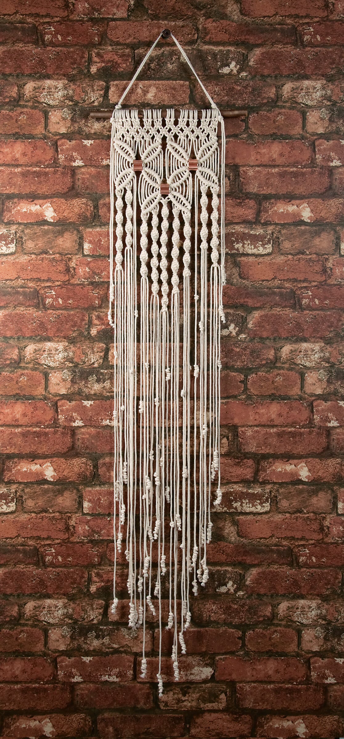 Solid Oak DIY macrame wall hanging kit - Flowers design, shown on brick background