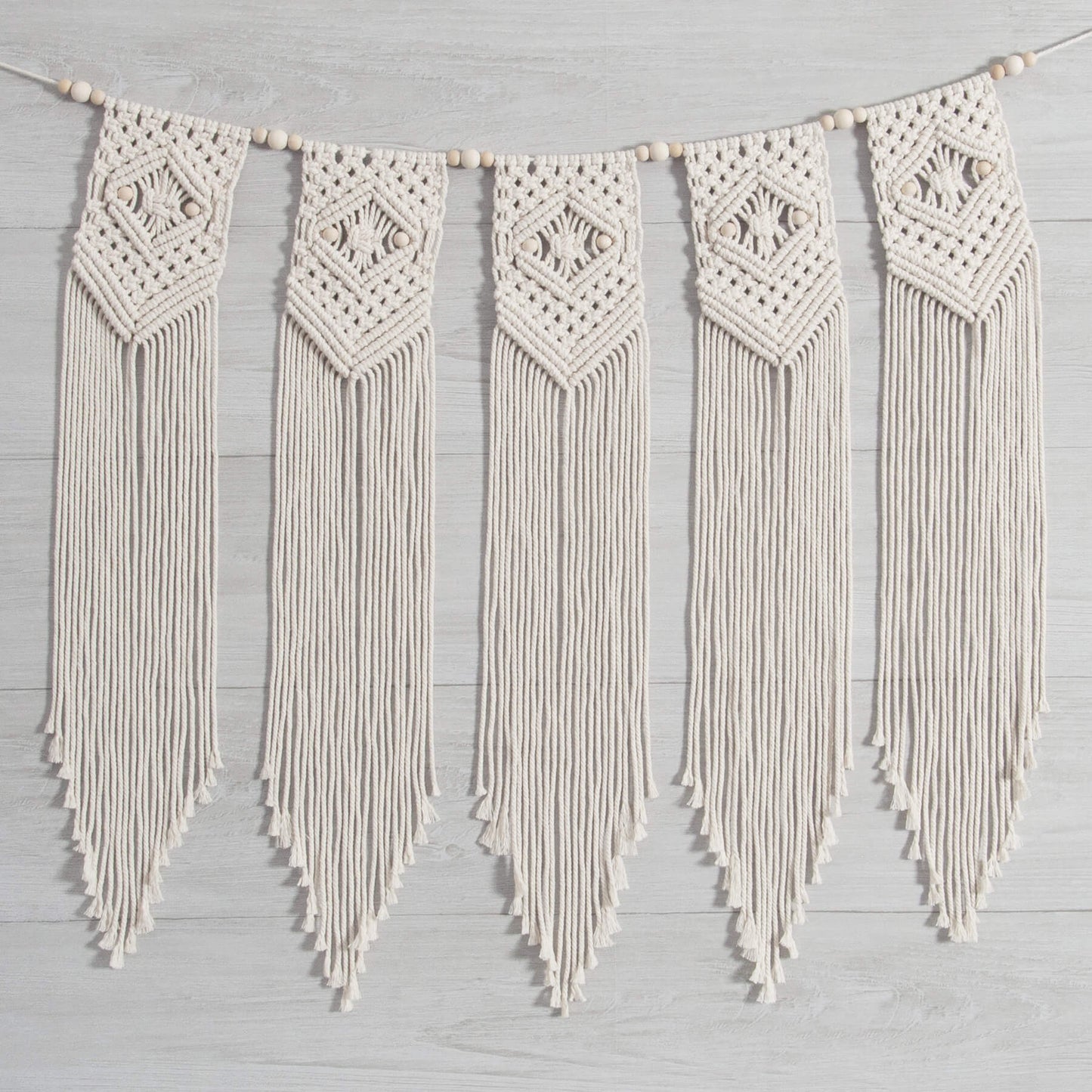 Solid Oak DIY macrame kit: Beaded Banner shown on light grey wood wall