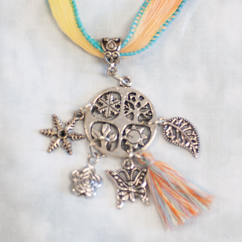 The Brianna "Four Seasons" dangling charm, shown on a silk ribbon. Instant jewelry!