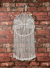 SOlid Oak's Dragonfly design macrame kit - shown as made up, on red brick