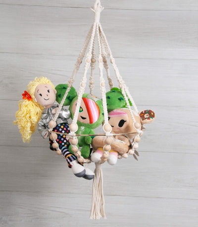 Solid Oak DIY macrame beaded chandelier kit, shown made up. Includes cotton macrame cord, metal hoop, and wood beads. Shown with random plush toys for lifestyle idea.