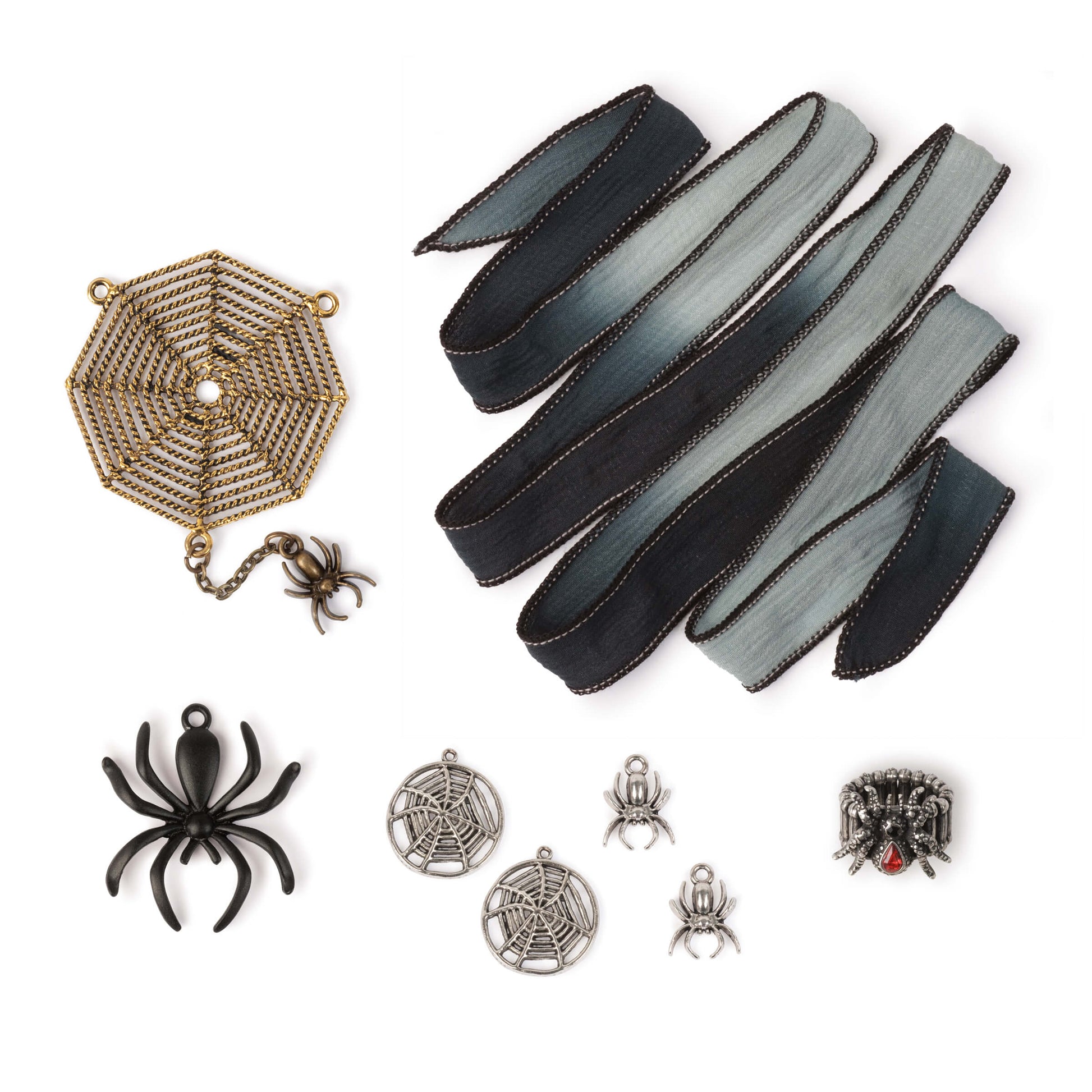 "Spiders" is our Style Bundle designer value set that is ideal for lovers of arachnids, or for Halloween. Set includes gold-color metal spider web statement pendant with spider attached by jewelry chain, large matte black metal spider pendant, stretch ring (one-size) with spider featuring a ruby red rhinestone accent, a pair of silver-toned spider charms, a pair of matching spider web charms, and a hand-dyed silk ribbon with black and grey tones.